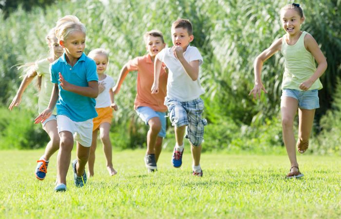 niños corriendo por el parque, jugando a atrapa la bandera Atrapa la bandera