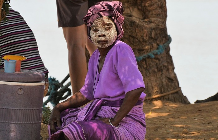 Mascarilla facial típica de Madagascar para protegerse del sol Mujer con la mascarilla facial típica de Madagascar