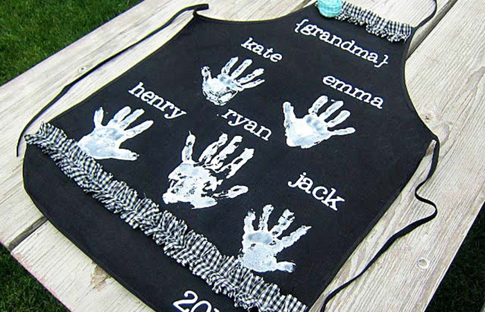 manualidades para los abuelos: delantal negro con huellas blancas de manitas manualidades para los abuelos: delantal