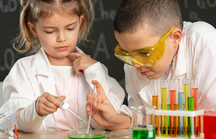 niños experimentando en laboratorio material científico: experimento