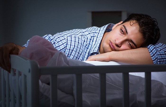 El Trastorno Obsesivo Compulsivo postparto puede causar insomnio El Trastorno Obsesivo Compulsivo postparto: padre cansado ante la cuna de su bebé